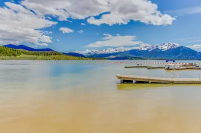 a dock on a lake with mountains in the background at Marina Place 336 in Dillon