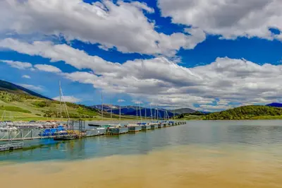 a dock on a lake with boats docked at Marina Place 336 in Dillon