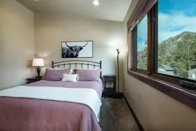a bedroom with a bed and a large window at Ridgeview Court Townhome: Incredible Rooftop Deck in Frisco