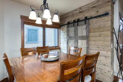 a dining room with a wooden table and chairs at Ridgeview Court Townhome: Incredible Rooftop Deck in Frisco