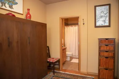 a bathroom with a wooden cabinet and a toilet at 1934 Soda Springs condo in Dillon