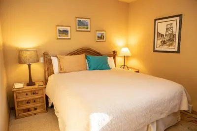 a bedroom with a large bed and two lamps at 1934 Soda Springs condo in Dillon