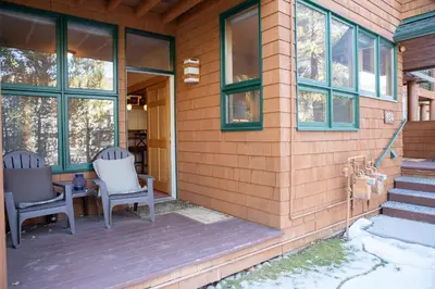 a porch of a house with two chairs and windows at 1934 Soda Springs condo in Dillon
