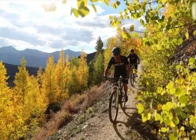 two people riding bikes down a dirt road at Tarn Landing Condo: Access To All Summit Resorts in Frisco