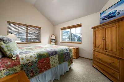 a bedroom with a bed and a dresser and a window at Tarn Landing Condo: Access To All Summit Resorts in Frisco
