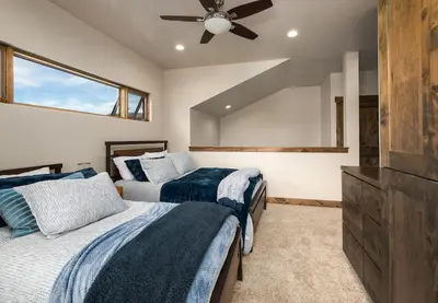 a bedroom with two beds and a ceiling fan at Deming Crossing Duplex: Downtown Frisco Chic in Frisco