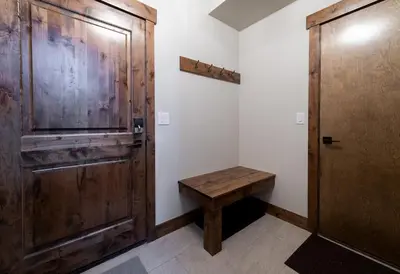a room with a wooden door and a wooden bench at Deming Crossing Duplex: Downtown Frisco Chic in Frisco