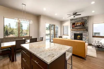 a kitchen and living room with a fireplace at Deming Crossing Duplex: Downtown Frisco Chic in Frisco