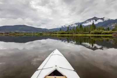 a kayak on a lake with mountains in the background at Deming Crossing Duplex: Downtown Frisco Chic in Frisco