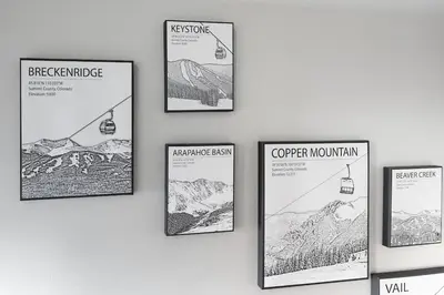 a group of posters hanging on a wall at Deming Crossing Duplex: Downtown Frisco Chic in Frisco