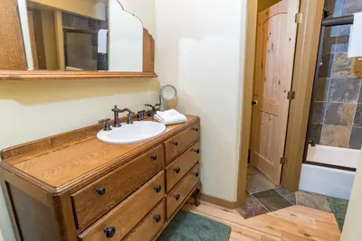 a bathroom with a sink and a mirror at Bear Creek Mining Lodge: Mountain Style, Hot Tub in Breckenridge Airport