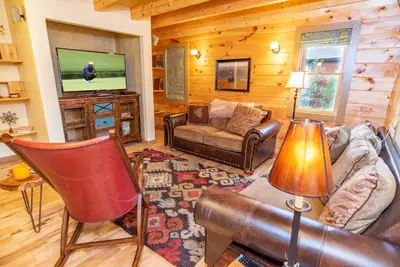 a living room with a couch and a tv at Bear Creek Mining Lodge: Mountain Style, Hot Tub in Breckenridge Airport