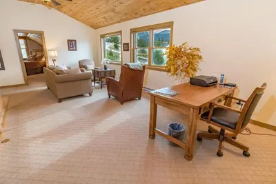 a living room with a wooden table and chairs at Bear Creek Mining Lodge: Mountain Style, Hot Tub in Breckenridge Airport
