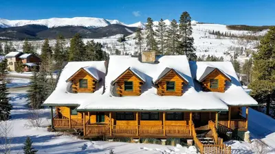 a log cabin with snow on the roof at Bear Creek Mining Lodge: Mountain Style, Hot Tub in Breckenridge Airport