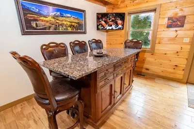 a kitchen with a large island with a granite counter top at Bear Creek Mining Lodge: Mountain Style, Hot Tub in Breckenridge Airport