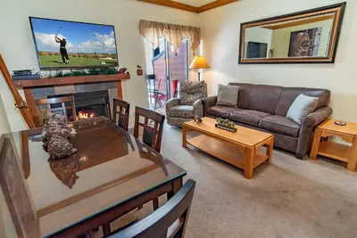 a living room with a couch and a fireplace at Mountainside Snowview Condo : Cool Frisco Location in Frisco
