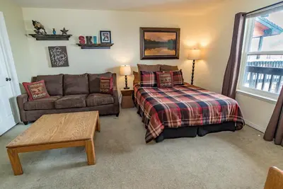 a living room with a bed and a couch at Mountainside Snowview Condo : Cool Frisco Location in Frisco