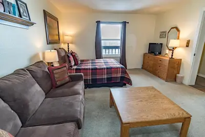 a living room with a couch and a bed at Mountainside Snowview Condo : Cool Frisco Location in Frisco