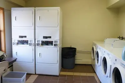 a laundry room with two white refrigerators and a counter at Mountainside Snowview Condo : Cool Frisco Location in Frisco