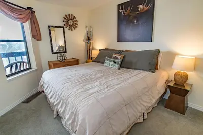 a bedroom with a large bed and a window at Mountainside Snowview Condo : Cool Frisco Location in Frisco