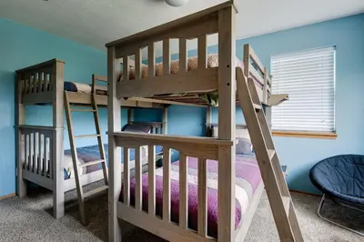 two bunk beds in a room with blue walls at Blue Granite Off Main Townhome: Updated, Great Location in Frisco