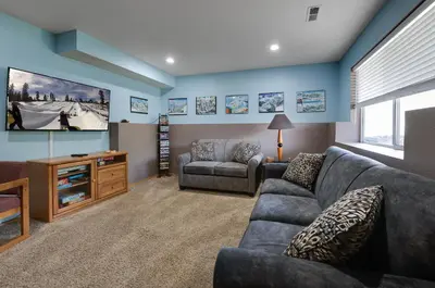 a living room with a couch and a tv at Blue Granite Off Main Townhome: Updated, Great Location in Frisco
