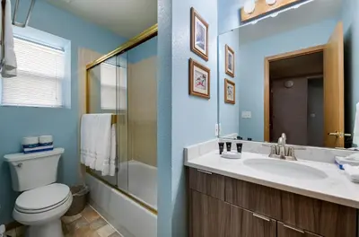 a bathroom with a sink and a toilet and a mirror at Blue Granite Off Main Townhome: Updated, Great Location in Frisco