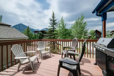 three chairs and a grill on a deck with mountains at Blue Granite Off Main Townhome: Updated, Great Location in Frisco