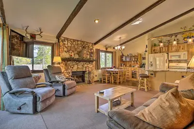 a living room with couches and a table and a kitchen at Walk to Town Updated Frisco Cabin with 2 Decks! in Frisco