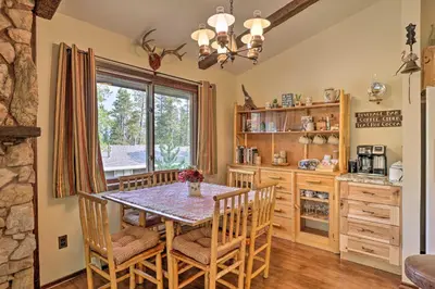 a kitchen with a table and chairs and a window at Walk to Town Updated Frisco Cabin with 2 Decks! in Frisco