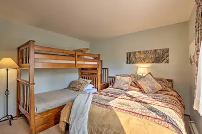 a bedroom with a bed and a bunk bed at Walk to Town Updated Frisco Cabin with 2 Decks! in Frisco