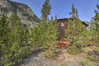 a small wooden building in the middle of a forest at Walk to Town Updated Frisco Cabin with 2 Decks! in Frisco