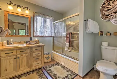 a bathroom with a toilet sink and a shower at Walk to Town Updated Frisco Cabin with 2 Decks! in Frisco