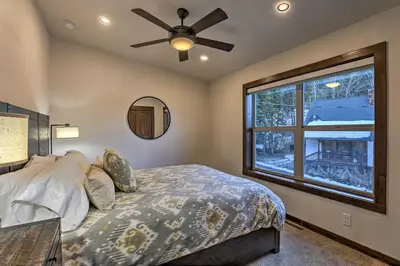 a bedroom with a bed with a ceiling fan and a window at Mountain View Retreat, Walk to Winter Park Gondola in Winter Park