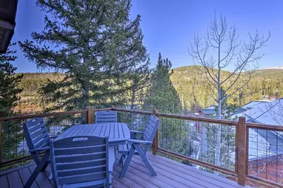 a wooden deck with a table and chairs on it at Mountain View Retreat, Walk to Winter Park Gondola in Winter Park