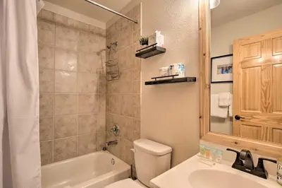 a bathroom with a tub and a sink and a toilet at 8 Mi to Keystone Mtn-View Ski Retreat! in Silverthorne