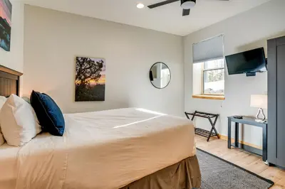 a bedroom with a large bed and a flat screen tv at 8 Mi to Keystone Mtn-View Ski Retreat! in Silverthorne