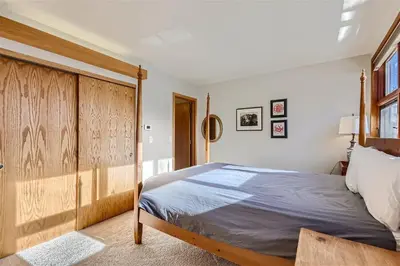 a bedroom with a large bed with a wooden headboard at Cabin Creek Condos C-1 condo in Frisco