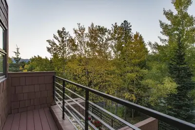 a balcony with a view of the woods at Cabin Creek Condos C-1 condo in Frisco