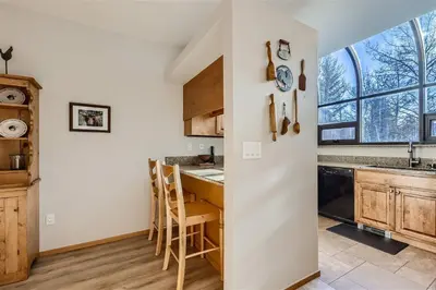 a kitchen with a counter and a table with chairs at Cabin Creek Condos C-1 condo in Frisco