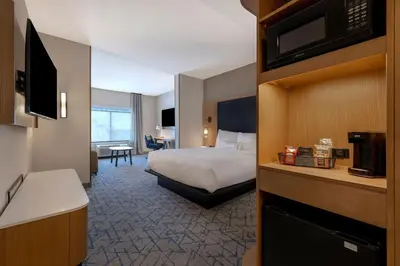 a hotel room with a bed and a television at Fairfield by Marriott Inn & Suites Denver Airport at Gateway Park in Denver