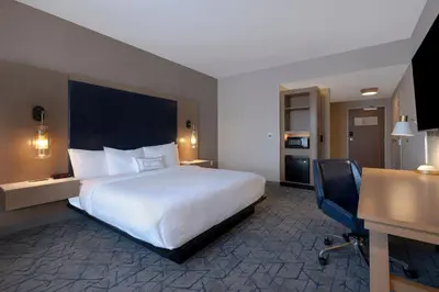 a hotel room with a large bed and a desk at Fairfield by Marriott Inn & Suites Denver Airport at Gateway Park in Denver