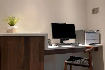 a desk with a computer and a printer on it at Fairfield by Marriott Inn & Suites Denver Airport at Gateway Park in Denver