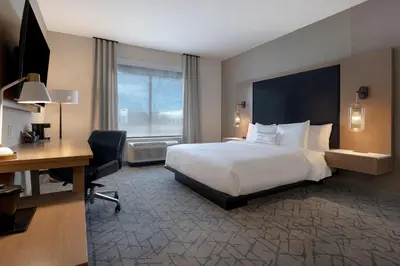 a hotel room with a large bed and a desk at Fairfield by Marriott Inn & Suites Denver Airport at Gateway Park in Denver