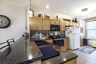 a kitchen with a counter top and a refrigerator at Saddle Ridge in Silverthorne