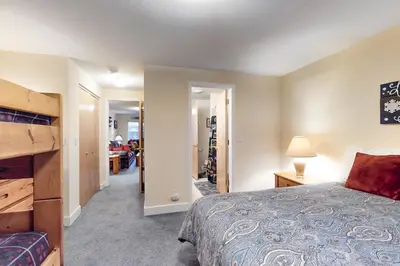 a bedroom with a bed and a living room at Saddle Ridge in Silverthorne