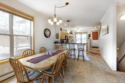 a dining room and kitchen with a table and chairs at Saddle Ridge in Silverthorne