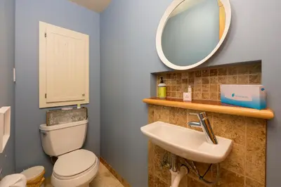a bathroom with a toilet and a sink and a mirror at 383 County Road 508 by Stay Winter Park in Fraser