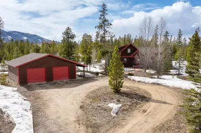 an aerial view of a home with a dirt road in front at 383 County Road 508 by Stay Winter Park in Fraser
