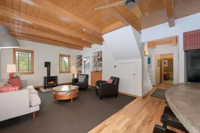 a living room with wooden ceilings and a fireplace at 383 County Road 508 by Stay Winter Park in Fraser
